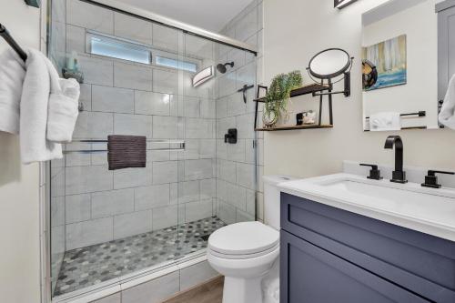a bathroom with a shower and a toilet and a sink at Tower 9 #4 in Oceanside