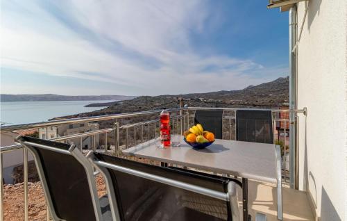 a table with a bowl of fruit on a balcony at Nice Apartment In Ribarica - Karlobag in Matić Podi
