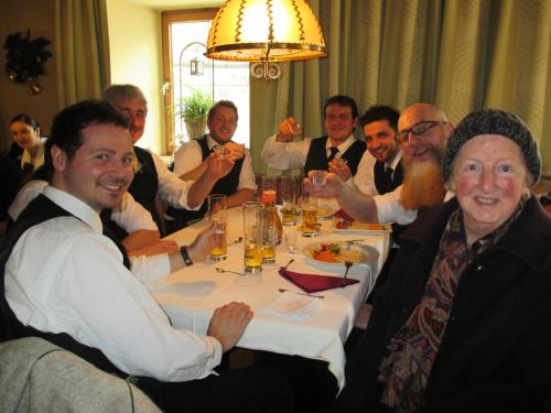 a group of men sitting around a table eating food at Hotel Untermetzger in Zell am Ziller