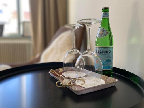 a table with two glasses and a bottle of wine at Mollösunds Wärdshus in Mollösund
