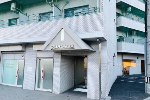 a building with a sign on the front of it at マリオン屋島東906号 in Sanuki