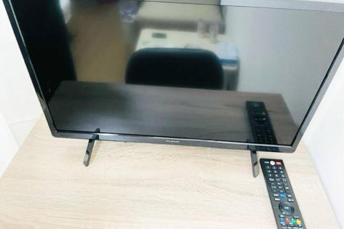 a computer monitor with a remote control on a table at マリオン屋島東906号 in Sanuki