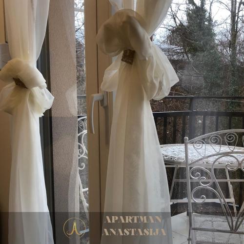 a bride in a white wedding dress on a window at Apartman Anastasija Vrnjačka Banja in Vrnjačka Banja