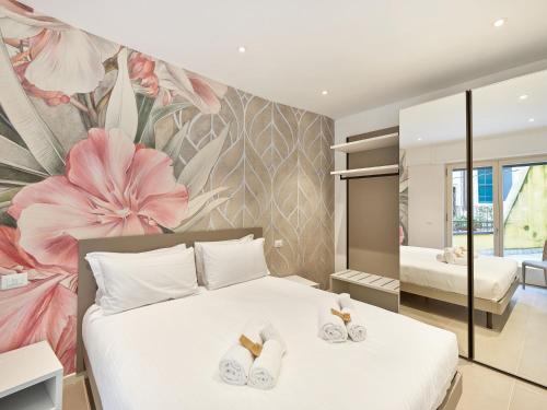 a bedroom with a bed with a flower wall at ApartmentsArena - Residenza Dei Doganieri - Verona in Verona