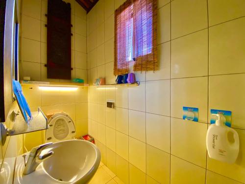 a bathroom with a sink and a mirror at 彼岸古厝民宿-包棟優先--Biiann B&B in Jinning