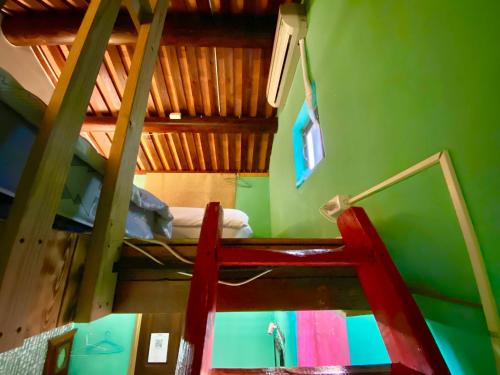 a ladder leading up to a bunk bed in a room at 彼岸古厝民宿-包棟優先--Biiann B&B in Jinning