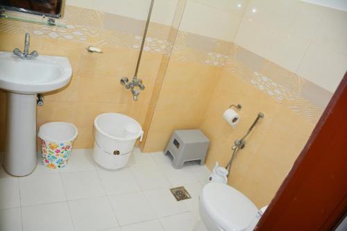 a bathroom with a toilet and a sink at Khyber Guest House Swat in Saidu