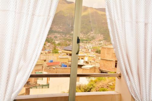 a window with a view of a city at Khyber Guest House Swat in Saidu