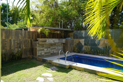 a swimming pool in a yard next to a fence at Marineros Vallarta in Puerto Vallarta