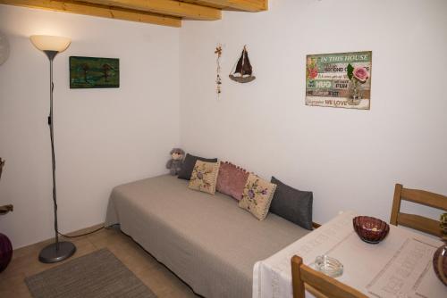 a bedroom with a bed and a table with a lamp at Ifigenia Cheerful and Cosy Entire Home with patio! in Anilio Pelion