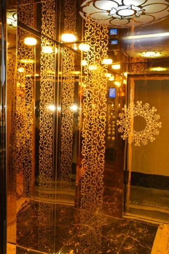 a room with a glass door with a wall with a mirror at Khyber Guest House Swat in Saidu