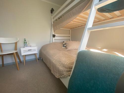 a bedroom with a bunk bed and a desk at Mollösunds Wärdshus in Mollösund
