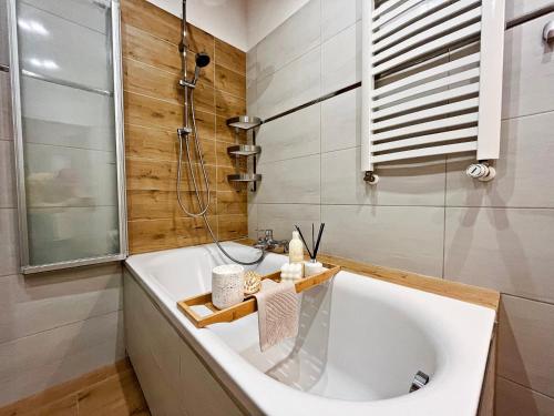 a bathroom with a tub and a shower and a sink at HARMONY Apartment - Zator Energylandia in Zator