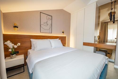 a bedroom with a large white bed in a room at Enyana Luxury Suites in Kotor