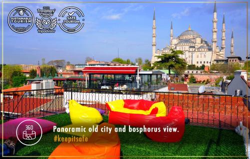 a view of a mosque with colorful furniture on the grass at Angel's Home Hotel - Angel Group Hotels in Istanbul