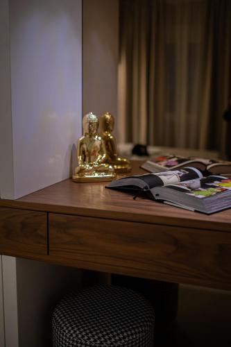 a desk with a gold statue on top of it at Enyana Luxury Suites in Kotor