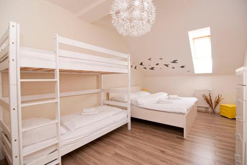 a bedroom with two bunk beds and a chandelier at Apartmán Lomnica - Vysoké Tatry in Veľká Lomnica
