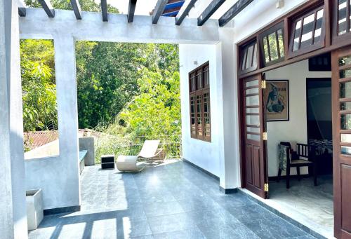 a living room with a door and a patio at Isana Beach House in Tangalle