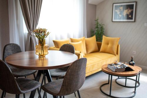 a living room with a couch and a table and chairs at Enyana Luxury Suites in Kotor