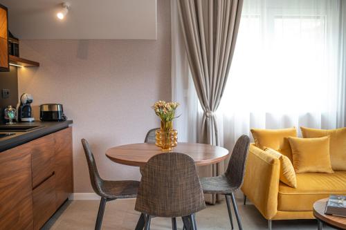 a kitchen and dining room with a table and chairs at Enyana Luxury Suites in Kotor