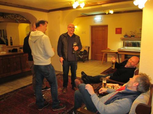 a group of men standing in a room with people at Hotel Untermetzger in Zell am Ziller