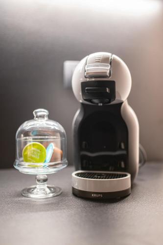 a coffee maker next to a glass bowl of food at Enyana Luxury Suites in Kotor