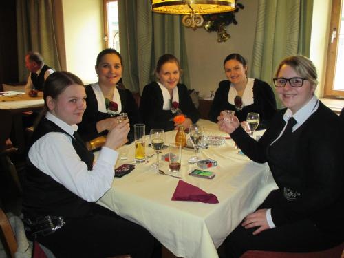 a group of women sitting around a table with wine glasses at Hotel Untermetzger in Zell am Ziller