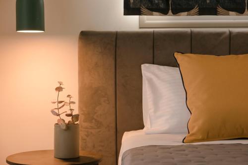 a bedroom with a bed and a table with a vase on it at Claire villa in Sami