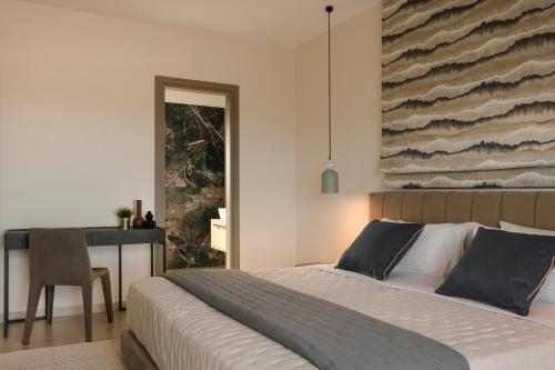a bedroom with a bed and a desk with a chair at Claire villa in Sami