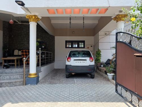 a small car parked inside of a house at NALINAM HOMESTAY in Trivandrum