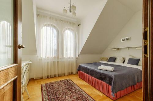 a bedroom with a large bed in a attic at Golden Apartments Zakopane&S3 in Zakopane