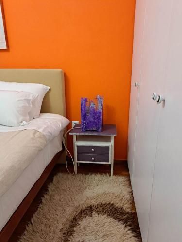 a bedroom with a bed and a nightstand with a table at Mary's Home Center City F in Aigio