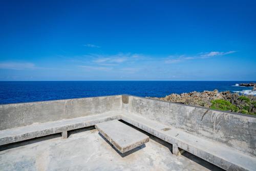 a concrete bench with the ocean in the background at Izustarri in Burgos