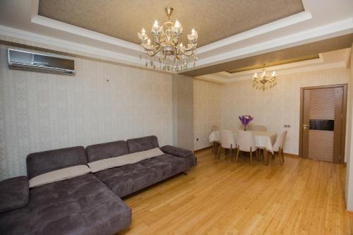 a living room with a couch and a dining room at HappyHome in Masazır