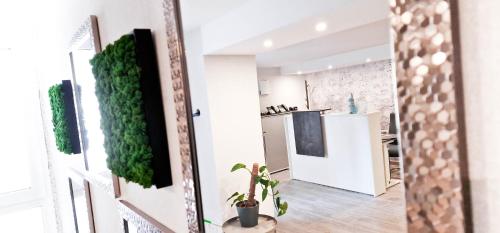 uma cozinha e sala de estar com uma planta na parede em SOFI-LIVING-APARTMENTS em Hanôver
