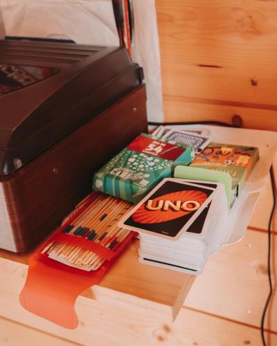 a pile of books sitting next to an open suitcase at Domaine de la Fauvriere in Sainte-Honorine-de-Ducy