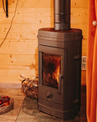 a wood stove in the corner of a room at Domaine de la Fauvriere in Sainte-Honorine-de-Ducy