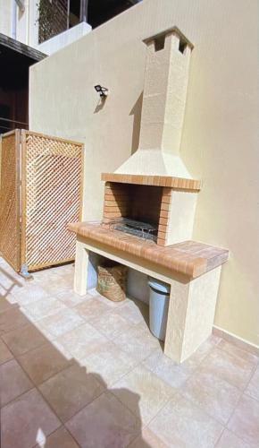 a outdoor pizza oven sitting on a patio at Arbutus - Relaxing apartment with Fantastic Views in Georgioupolis