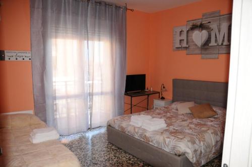 a bedroom with a bed and a desk with a laptop at Andrea affittacamere e B&B in Solignano Nuovo