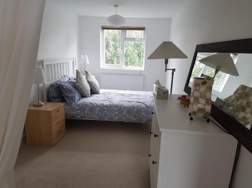 a small bedroom with a bed and a window at 1 bed apartment in West London in Heston