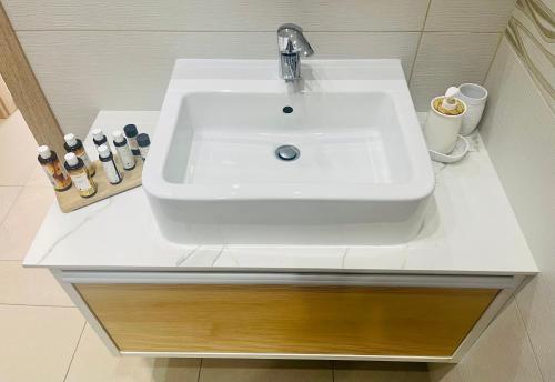 a white sink in a bathroom with a counter at Riverside Suite in Kalopanayiotis