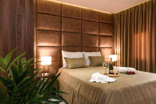 a bedroom with a bed with two lamps and wine glasses at Luxury Rooms LaVie - Standard Rooms in Zadar