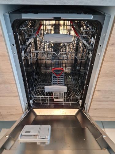 an empty dishwasher with two dishes in it at Scarpe House - Garage - Jardin - Wifi - Douai in Douai
