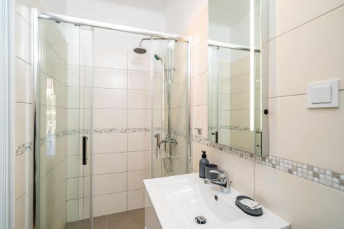 a bathroom with a sink and a shower at Studio Apartman LEMON in Dubrovnik
