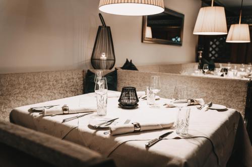 a table in a restaurant with a white table cloth at Hotel Hubertushof in Anif