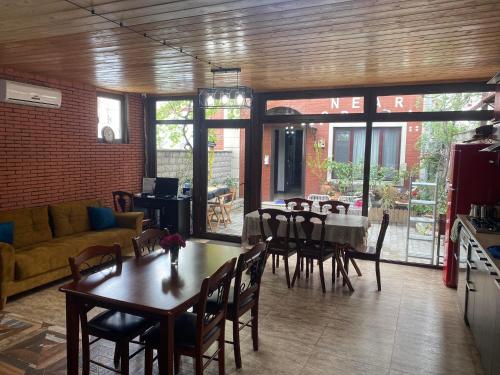 a living room with a table and chairs and a couch at Terrace House Near Opera in Tbilisi City