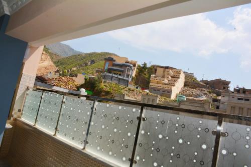 a balcony with a view of a city at Khyber Guest House Swat in Saidu