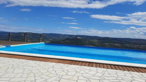 a swimming pool on top of a house at Villa San Silvestro in Oprtalj