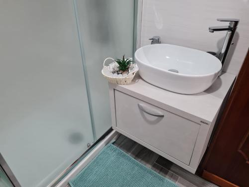 a bathroom with a white sink and a mirror at Sicilia Mount&Sea in Mascali
