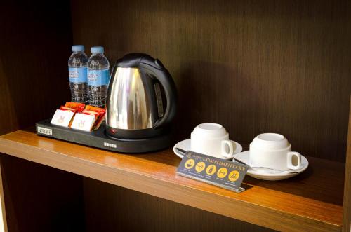 a coffee maker on a shelf in a hotel room at The Marison Hotel in Legazpi